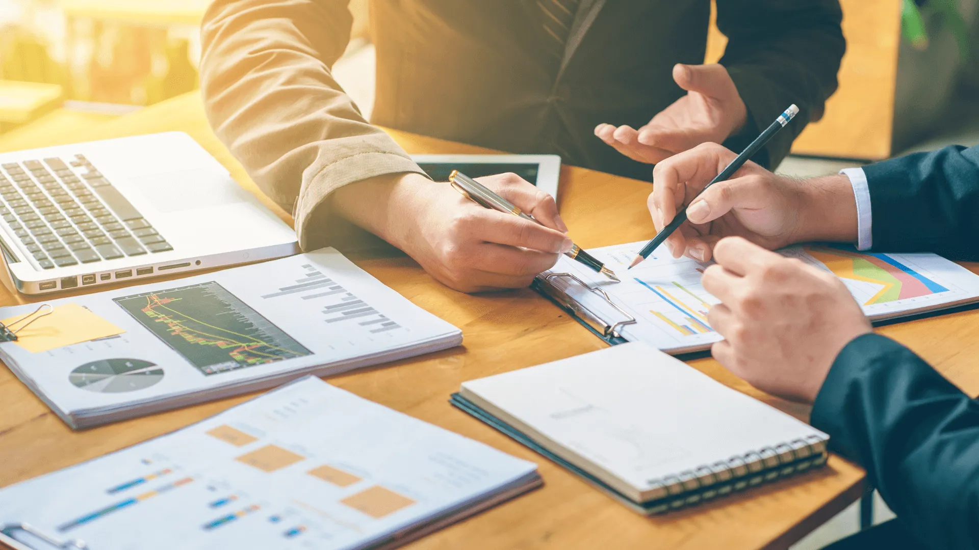 Team reviewing charts and reports at a desk