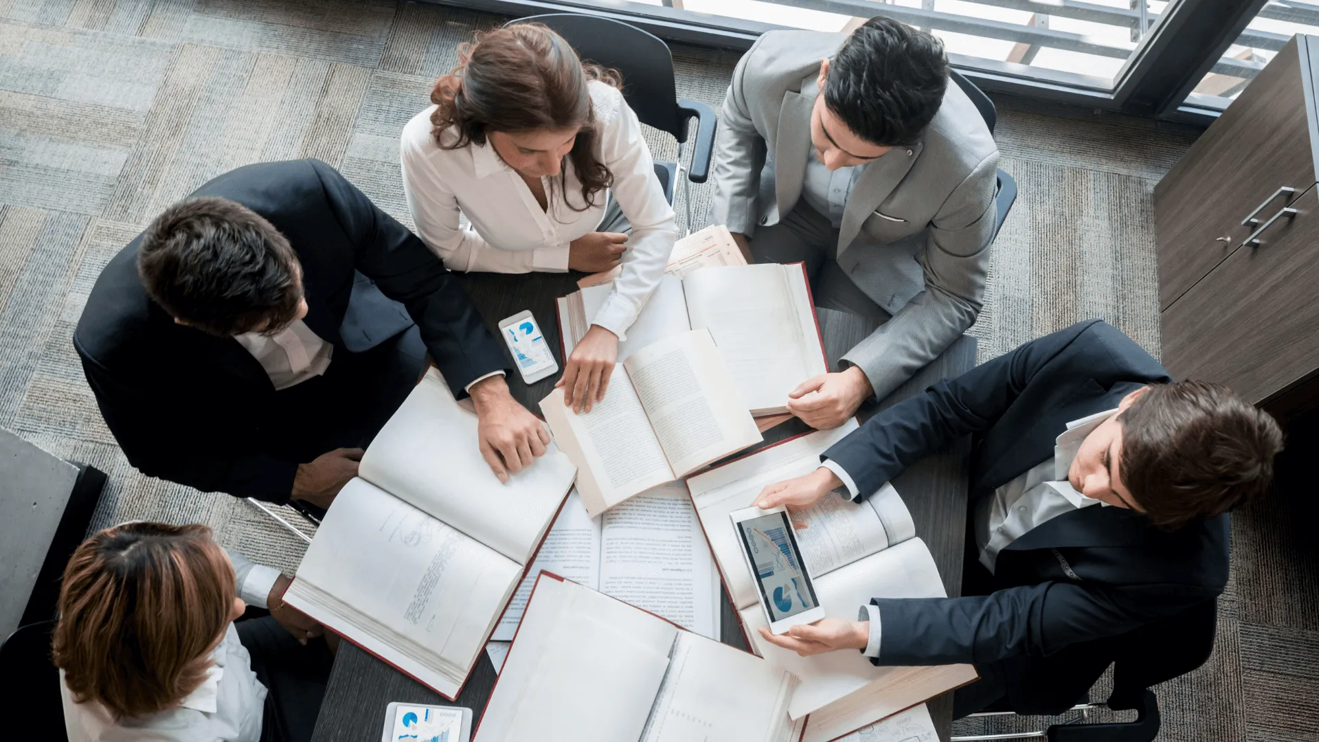 Team meeting around a table, seen from above